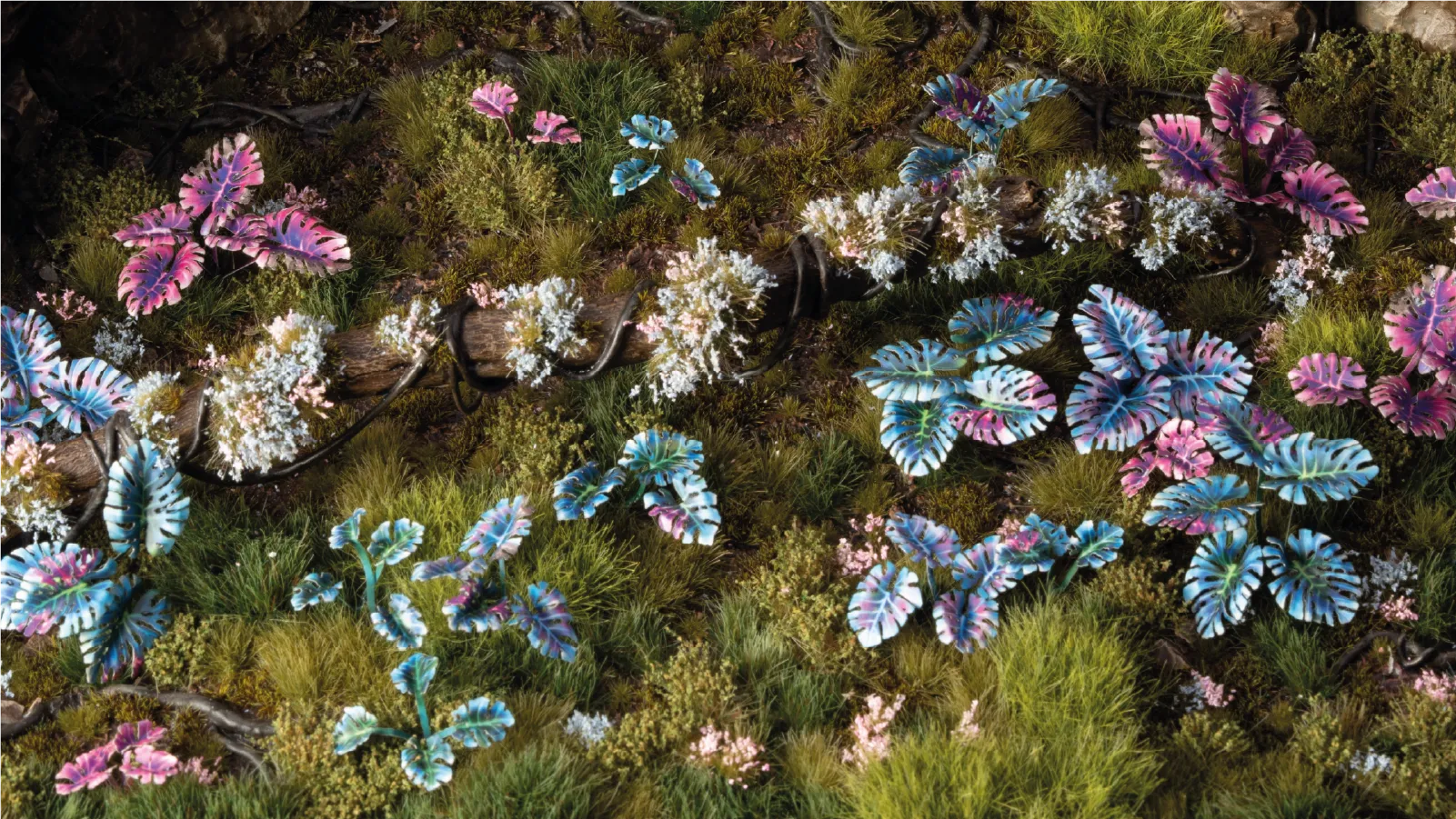 Gamers Grass Alien Monstera leaves placed on scenic diorama terrain with static grass and foliage
