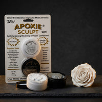 Aves Apoxie Sculpt White 1/4 lb product pack showing the retail blister card, Part A and Part B sample tubs, and a white sculpted rose beside the product
