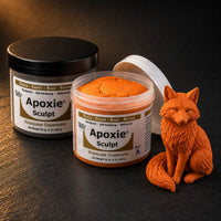 Aves Apoxie Sculpt 1lb Orange — Part A tub open showing orange putty, Part B tub behind, with a detailed sculpted sitting fox demonstrating fine fur texture detail
