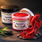 Aves Apoxie Sculpt 1lb Red — Part A tub open showing red putty, Part B tub behind, with a detailed sculpted koi fish leaping from water splash on river stones