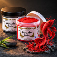 Aves Apoxie Sculpt 1lb Red — Part A tub open showing red putty, Part B tub behind, with a detailed sculpted koi fish leaping from water splash on river stones
