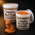 Aves Apoxie Sculpt 4lb Orange — large Part A and Part B tubs with orange putty visible, alongside a detailed sculpted sitting fox with fine fur texture