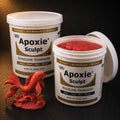Aves Apoxie Sculpt 4lb Red — large Part A and Part B tubs with red putty visible, alongside a detailed sculpted koi fish leaping from waves