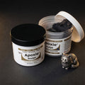 Aves Studio Apoxie Sculpt Black modelling compound with Part A and Part B jars beside a small black cat sculpture