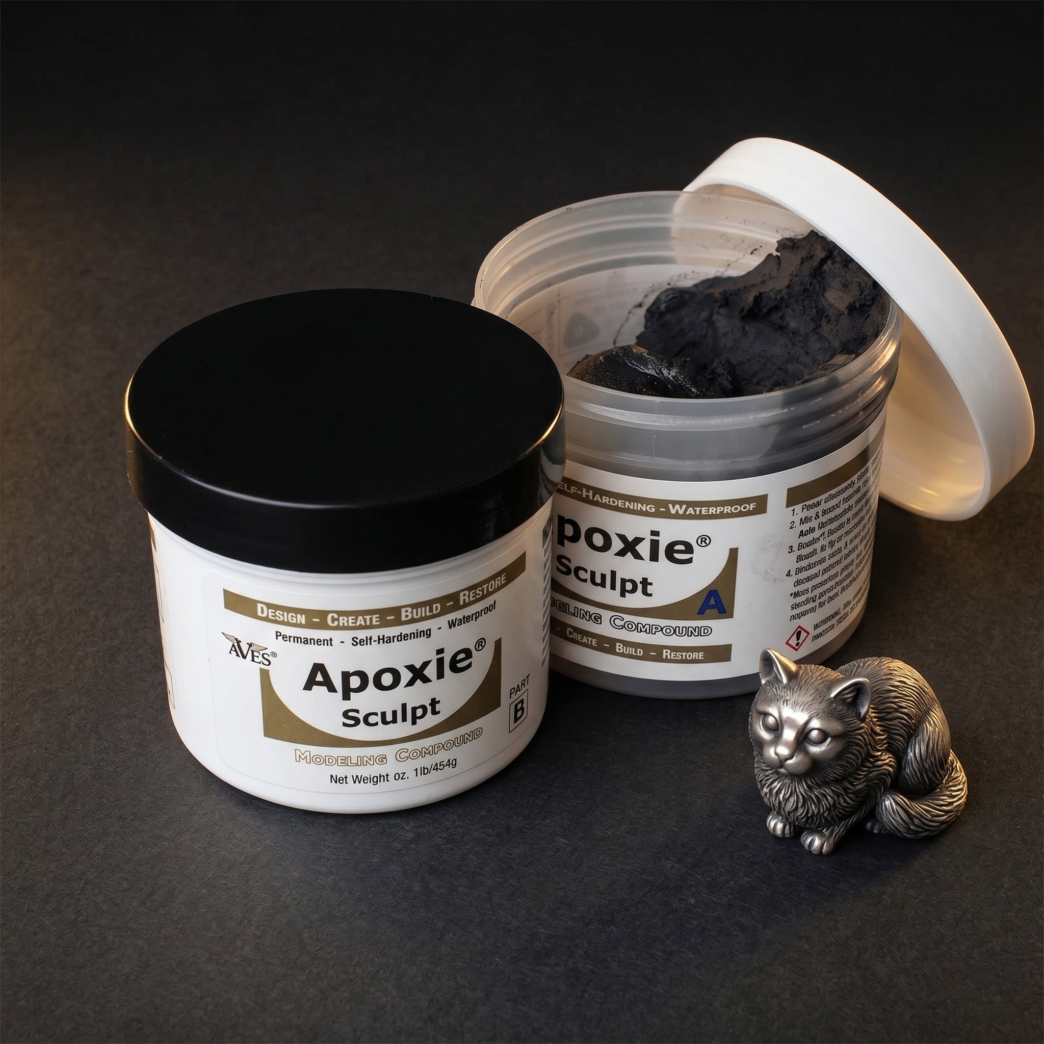 Aves Studio Apoxie Sculpt Black modelling compound with Part A and Part B jars beside a small black cat sculpture