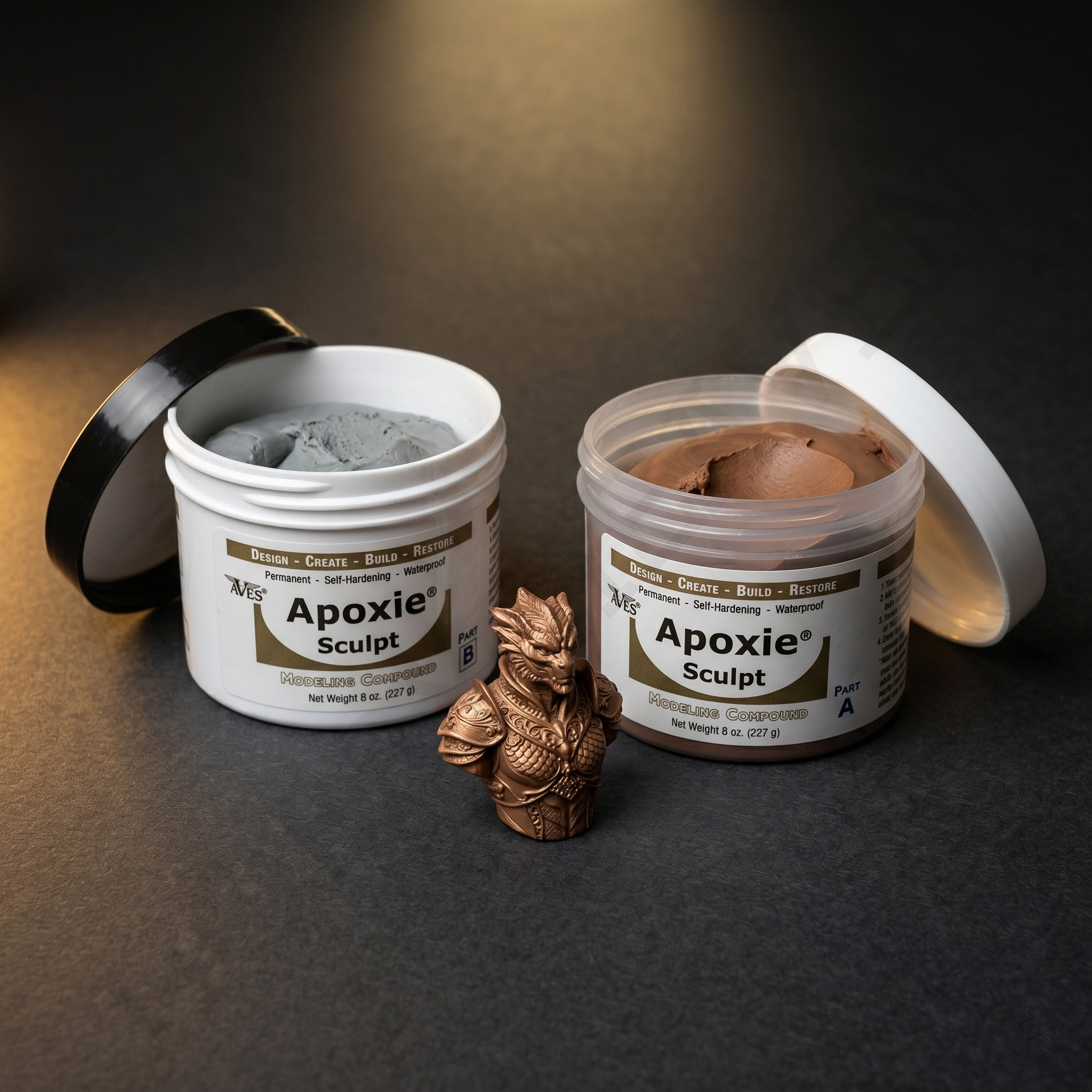 Aves Studio Apoxie Sculpt Bronze 1 lb with Part A and Part B jars beside a bronze fantasy bust sculpture