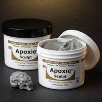 Close up of Aves Studio Apoxie Sculpt jars with opened modelling compound and a small sculpted grey piece
