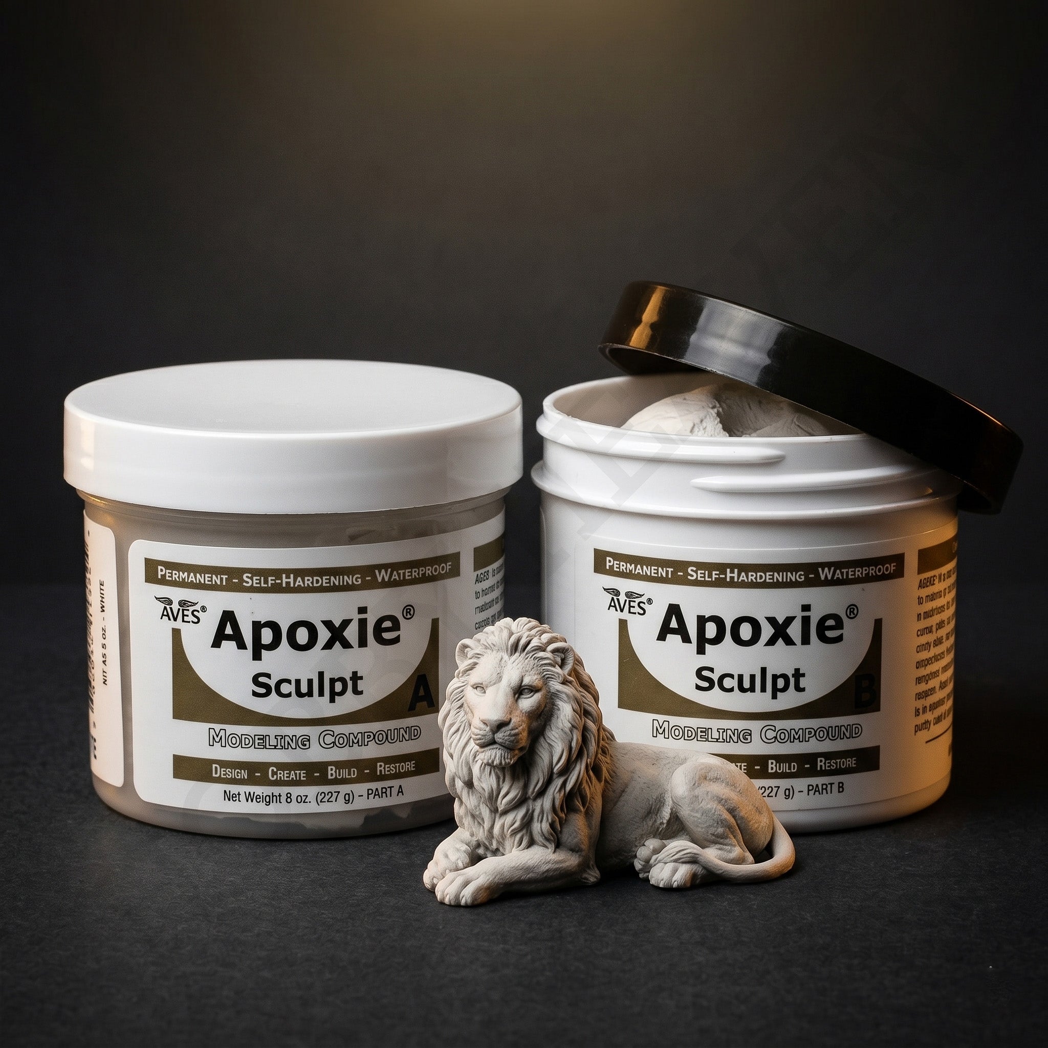 Aves Studio Apoxie Sculpt Stone Grey modelling compound with Part A and Part B jars beside a stone grey lion sculpture