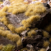 Realistic diorama featuring Beige 4mm - Small Tufts, showcasing a diverse arid landscape with desert areas, dry grasslands, and wheat fields, demonstrating the product's versatility in creating convincing dry environments
