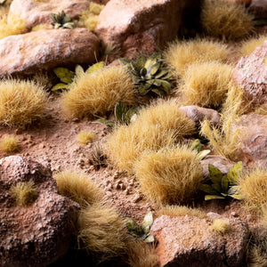 Dramatic diorama featuring Beige XL 12mm - Wild XL Tufts, showcasing a diverse tall, dry landscape with high pastures, mature crop fields, and arid terrain, demonstrating the product's effectiveness in creating depth and realism in miniature scenes