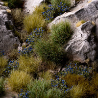 Lifelike diorama featuring Blue Flowers - Wild tufts, showcasing a serene landscape with varied textures, including wild blue flowering shrubs, elegant garden flowers, and fruiting bushes
