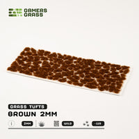 Sheet of 115 Brown 2mm Tufts, displaying various shapes and sizes of reddish-brown grass tufts ready for diverse applications
