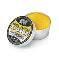 Yellow brush cleaning sponge in a container with 'Green Stuff World' branding on a white background.
