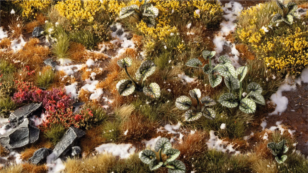 Gamers Grass Bugloss leaves placed on woodland diorama terrain with tufts heather and patches of snow