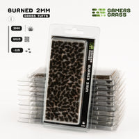 Gamers Grass Burned 2mm Tufts packaging, featuring dark, desolate landscape imagery that sets a somber mood
