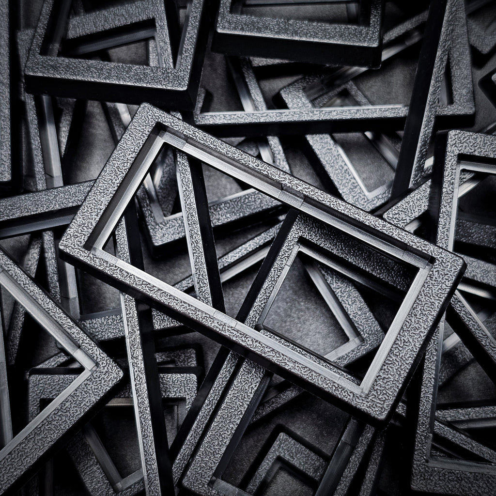 Close-up of 50x24mm to 60x30mm base converter – textured ABS plastic for wargaming