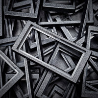 Close-up of 50x24mm to 60x30mm base converter – textured ABS plastic for wargaming