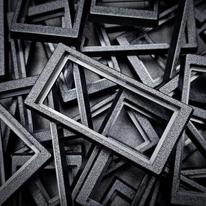 Close-up of 50x24mm to 60x30mm base converter – textured ABS plastic for wargaming