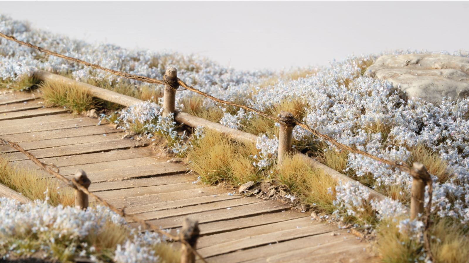 Miniature terrain decorated with Gamers Grass Cornflower Tiny Flowers – fine blue tufts for wargaming bases and scale model scenery