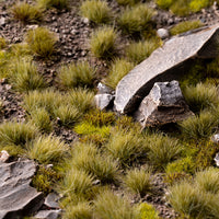 Miniature landscape diorama featuring Dry Green 6mm Small Tufts, showcasing realistic ground cover in a mixed terrain scene with model figures
