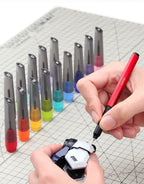 The red AT-EH01-PRO scribing a model part, with DSPIAE bits in coloured caps on a cutting mat (bits not included)