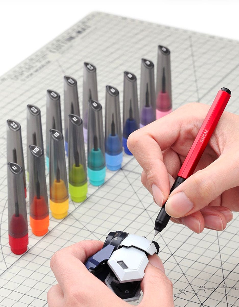 The red AT-EH01-PRO scribing a model part, with DSPIAE bits in coloured caps on a cutting mat (bits not included)