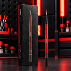 DSPIAE AT-FB01 red aluminium fine tip brush beside its black box, on a dark red-lit bench