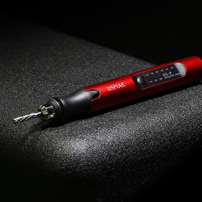 DSPIAE ES-P sanding pen lying on a dark surface with a cutter fitted and the indicator panel on the barrel