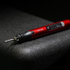 DSPIAE ES-P sanding pen lying on a dark surface with a cutter fitted and the indicator panel on the barrel