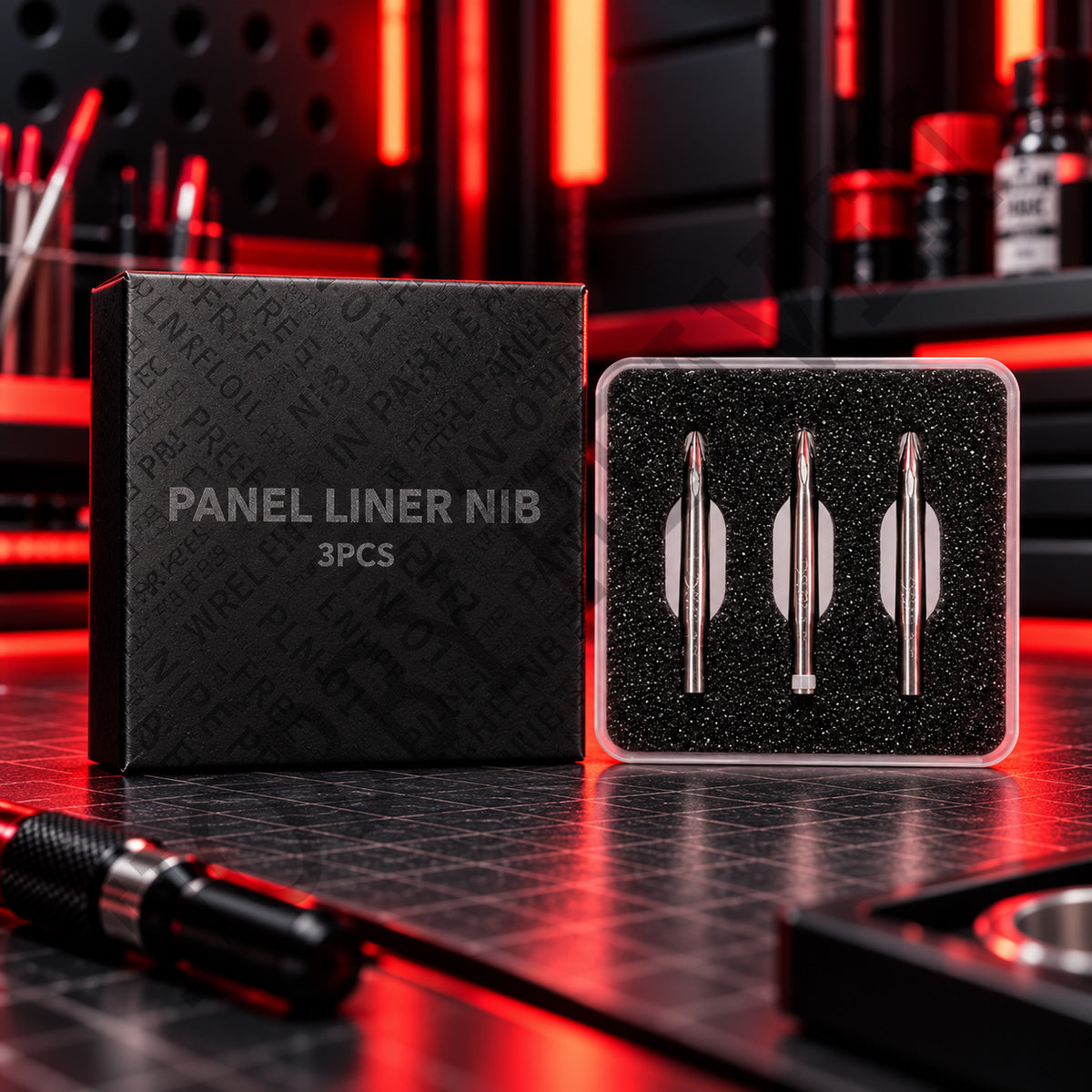 DSPIAE PLN-01 Panel Liner Nib box and three stainless steel nibs in a clear case on a red-lit desk