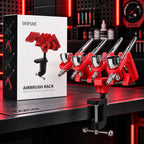 DSPIAE PT-AR rack clamped to a bench holding four airbrushes, beside its Airbrush Rack box