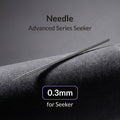 Gaahleri 0.3mm airbrush needle for Premium Series Mobius full length on dark textured surface with studio lighting
