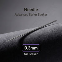 Gaahleri 0.3mm airbrush needle for Premium Series Mobius full length on dark textured surface with studio lighting
