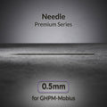 Gaahleri 0.5mm airbrush needle for Premium Series Mobius lying on textured surface with studio lighting
