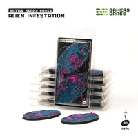 Gamers Grass packaging and two painted 90mm oval Alien Infestation bases displayed on white background

