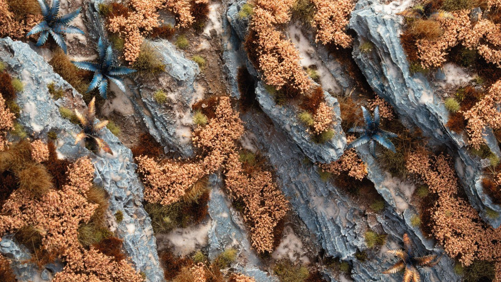 Diorama with Gamers Grass Autumn Shrubs tufts in yellow and brown shades on rocky terrain