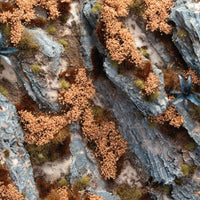 Diorama with Gamers Grass Autumn Shrubs tufts in yellow and brown shades on rocky terrain