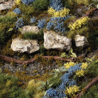 Gamers Grass Bluebeard Flowers Tufts applied on diorama terrain with rocks, shrubs and scenic basing for miniatures