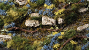 Gamers Grass Bluebeard Flowers Tufts applied on diorama terrain with rocks, shrubs and scenic basing for miniatures