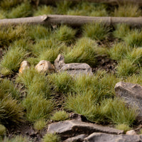 Lush diorama featuring Green 4mm - Small Tufts, showcasing a diverse landscape with grassland and forest floor elements, demonstrating the product's versatility in creating realistic scenery