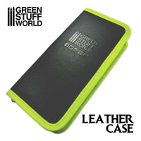 Black leather case with green edges on a white background, featuring 'Green Stuff World' branding.
