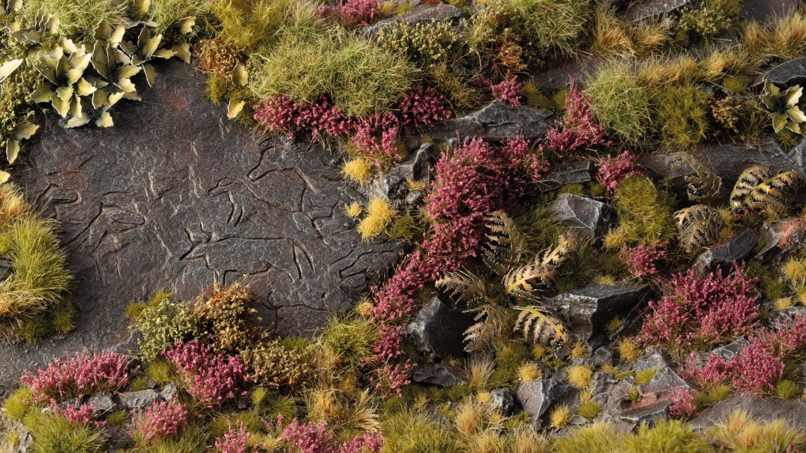 Miniature diorama decorated with Gamers Grass Heather Flowers tufts, showing purple heather on rocky moorlands with grass and plants.