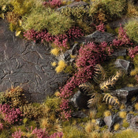 Miniature diorama decorated with Gamers Grass Heather Flowers tufts, showing purple heather on rocky moorlands with grass and plants.