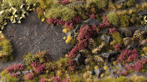 Miniature diorama decorated with Gamers Grass Heather Flowers tufts, showing purple heather on rocky moorlands with grass and plants.