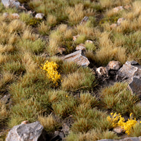 Realistic highland diorama featuring the Highland Tuft Set, showcasing a diverse upland landscape with scrubland, dwarf shrubs, and scattered yellow flowers
