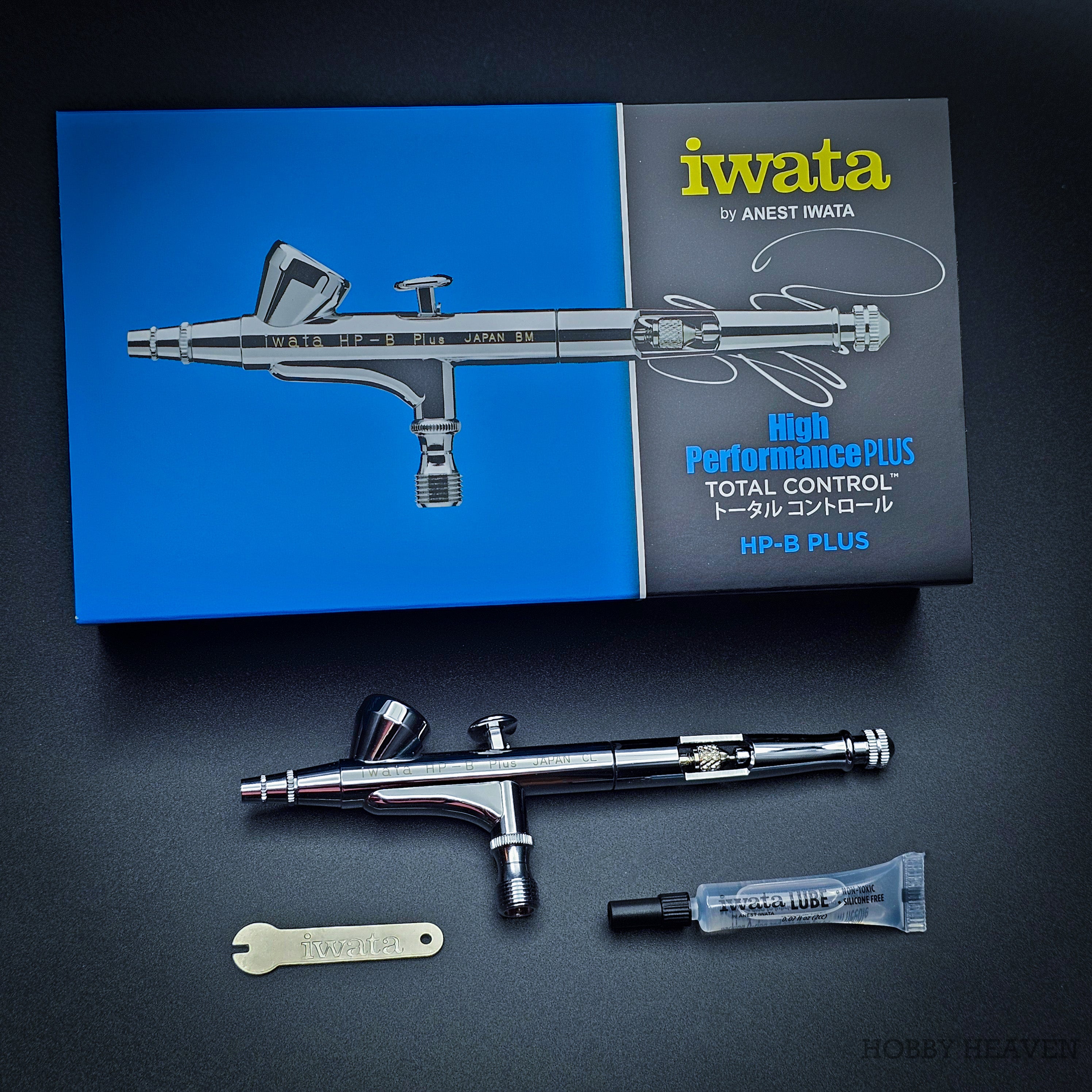 Iwata HP-B Plus professional airbrush top view on black background