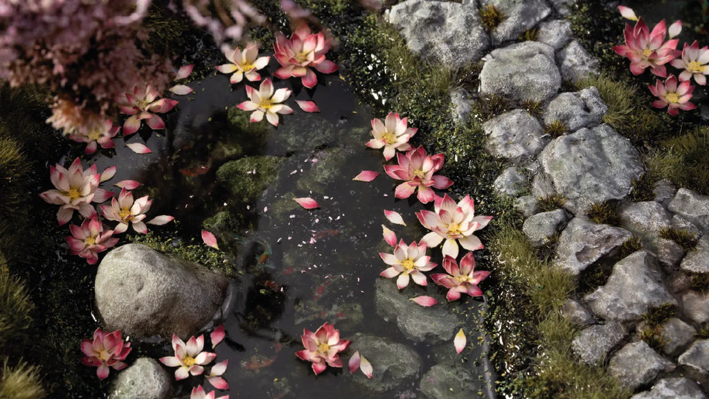 Gamers Grass Lotus Flower blooms placed on scenic pond diorama with resin water effect rocks and moss