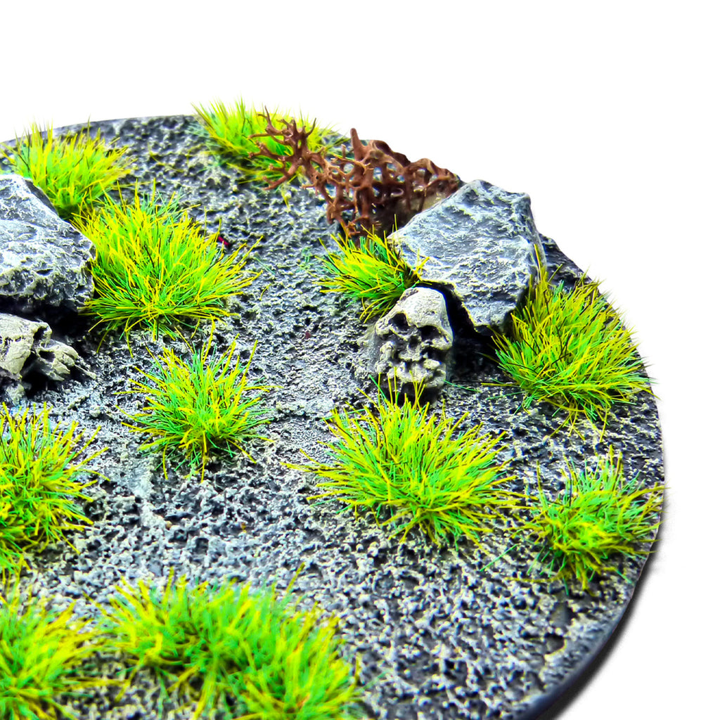 Fluor Grinch Green Martian Fluor Tufts planted on a grey textured base with a skull and rocks