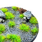 Fluor Grinch Green Martian Fluor Tufts planted on a grey textured base with a skull and rocks