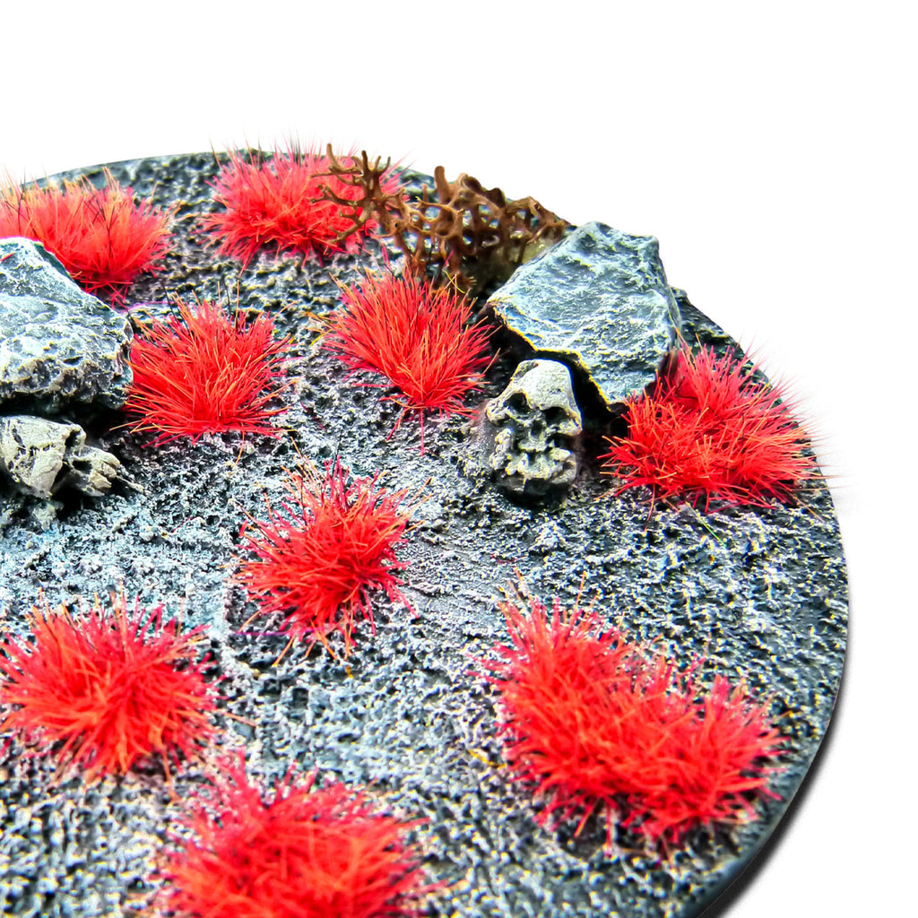 Neo-Mars Orange Martian Fluor Tufts planted on a grey textured base with a skull and rocks